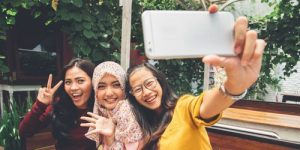 3 women taking selfies
