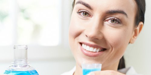 a doctor is holding a mouthwash