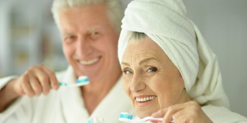 grandfather and grandmother brushing teeth