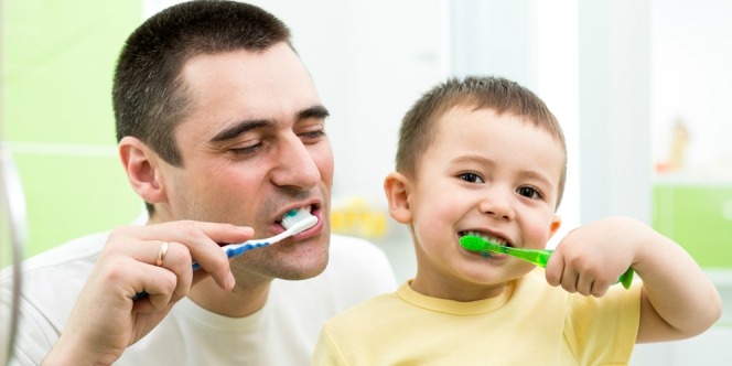 the father is inviting his son to brush his teeth